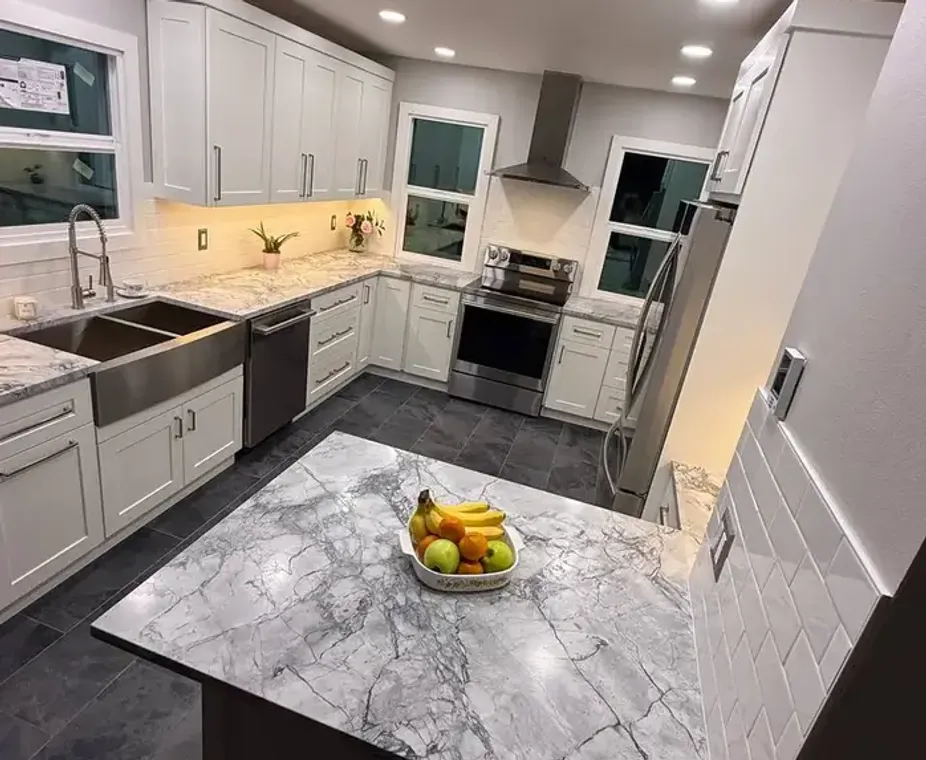 White quartz countertop with waterfall edge and dark cabinets
