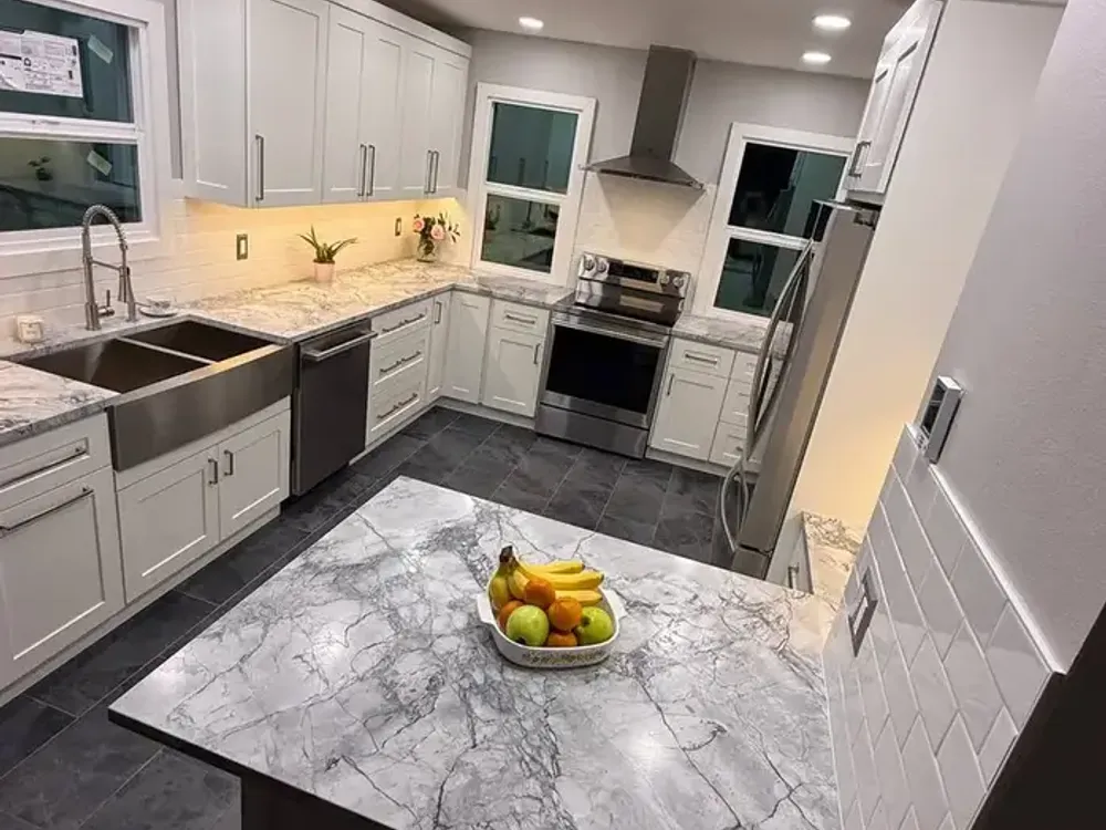 White quartz countertop with waterfall edge and dark cabinets