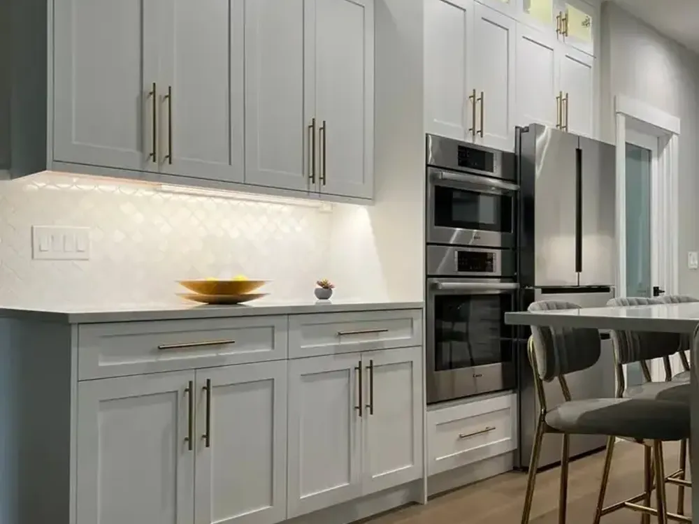 White Shaker kitchen cabinets with gold hardware installed in Bellevue WA