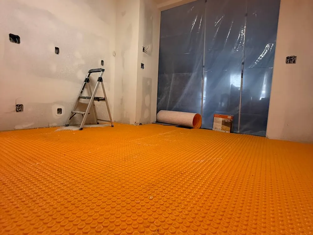 Electric radiant heating mat laid before tile