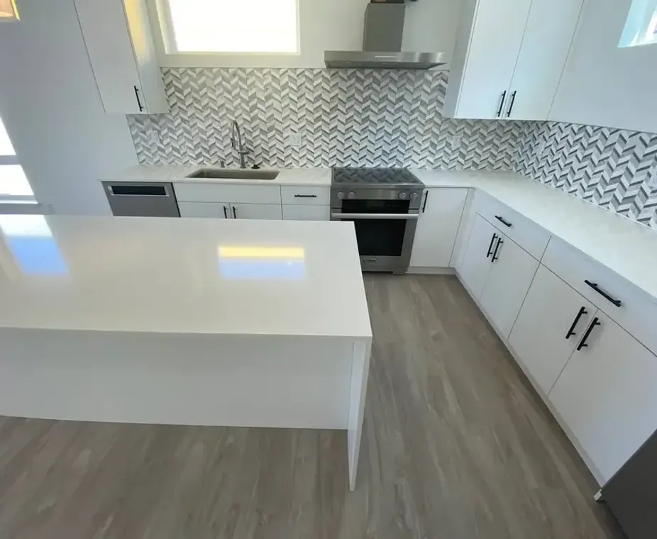 Gray kitchen with quartz island countertop and smart refrigerator