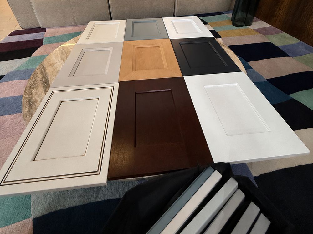 Cabinet door and stone samples that Rain City brings to a consultation, laid out on a table
