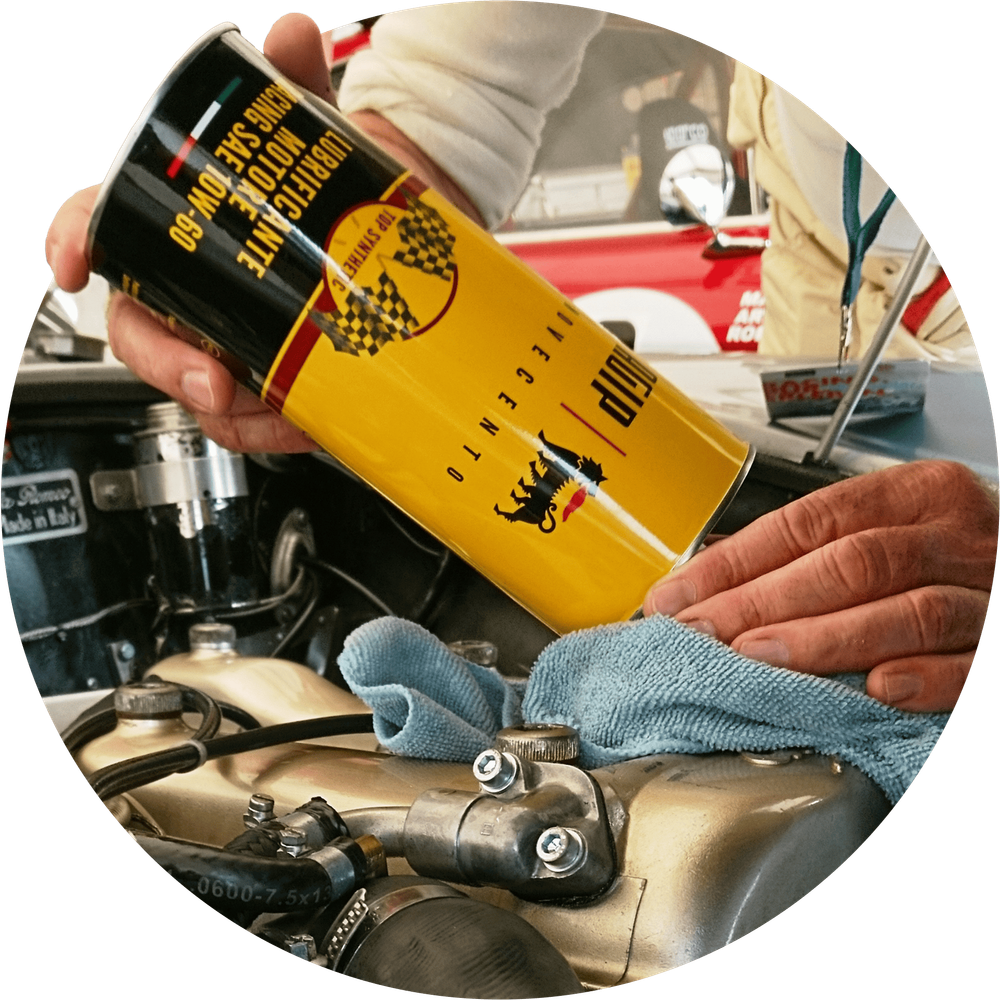 A technician pouring an ENI automotive product