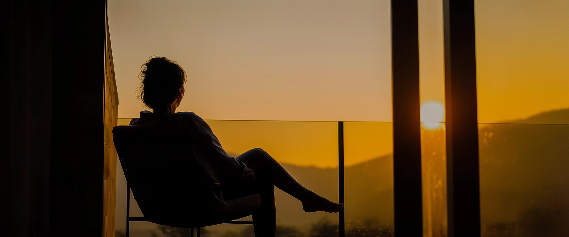 Woman enjoying the sunset holding a glass of wine