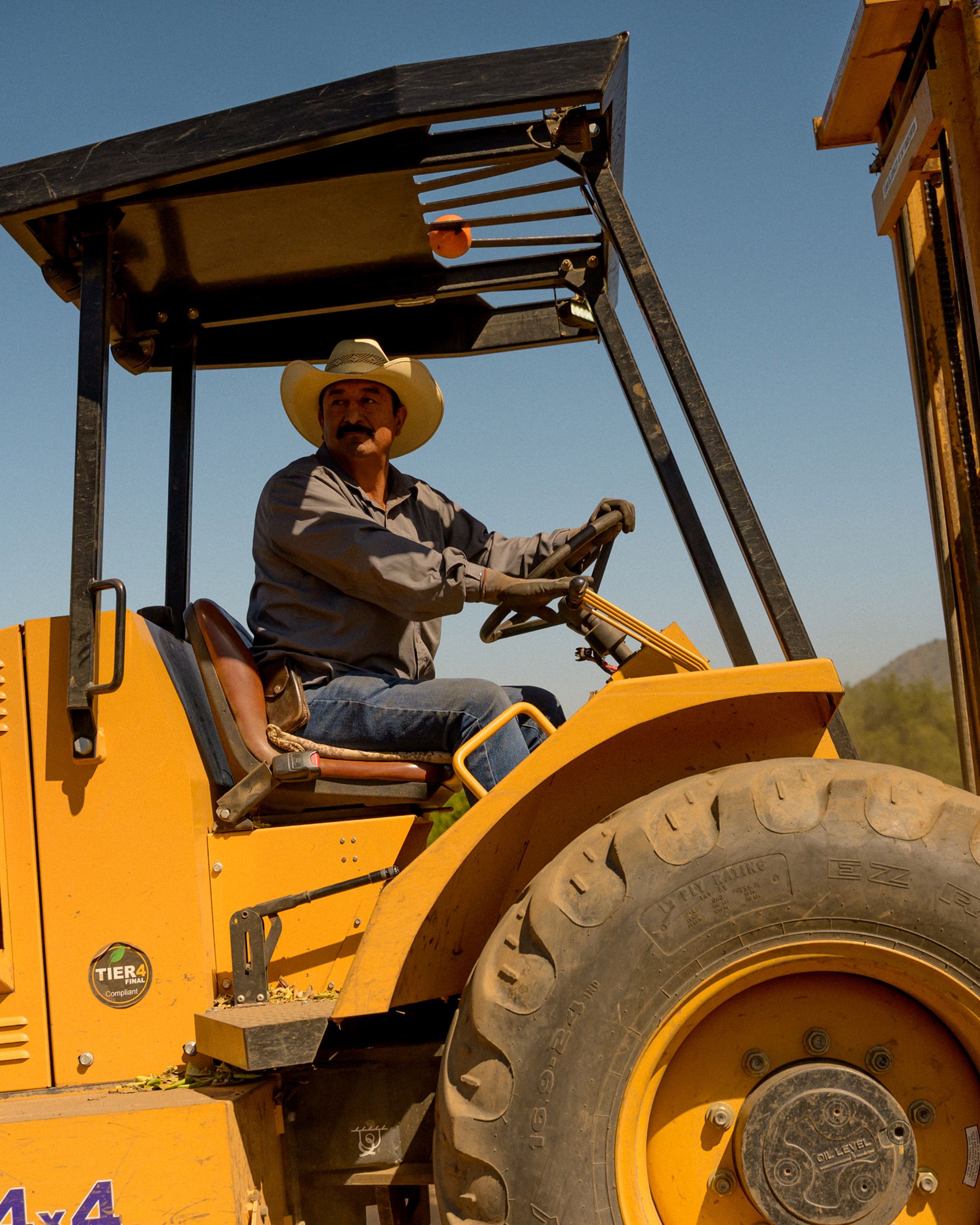 Farmer on yellow tractor