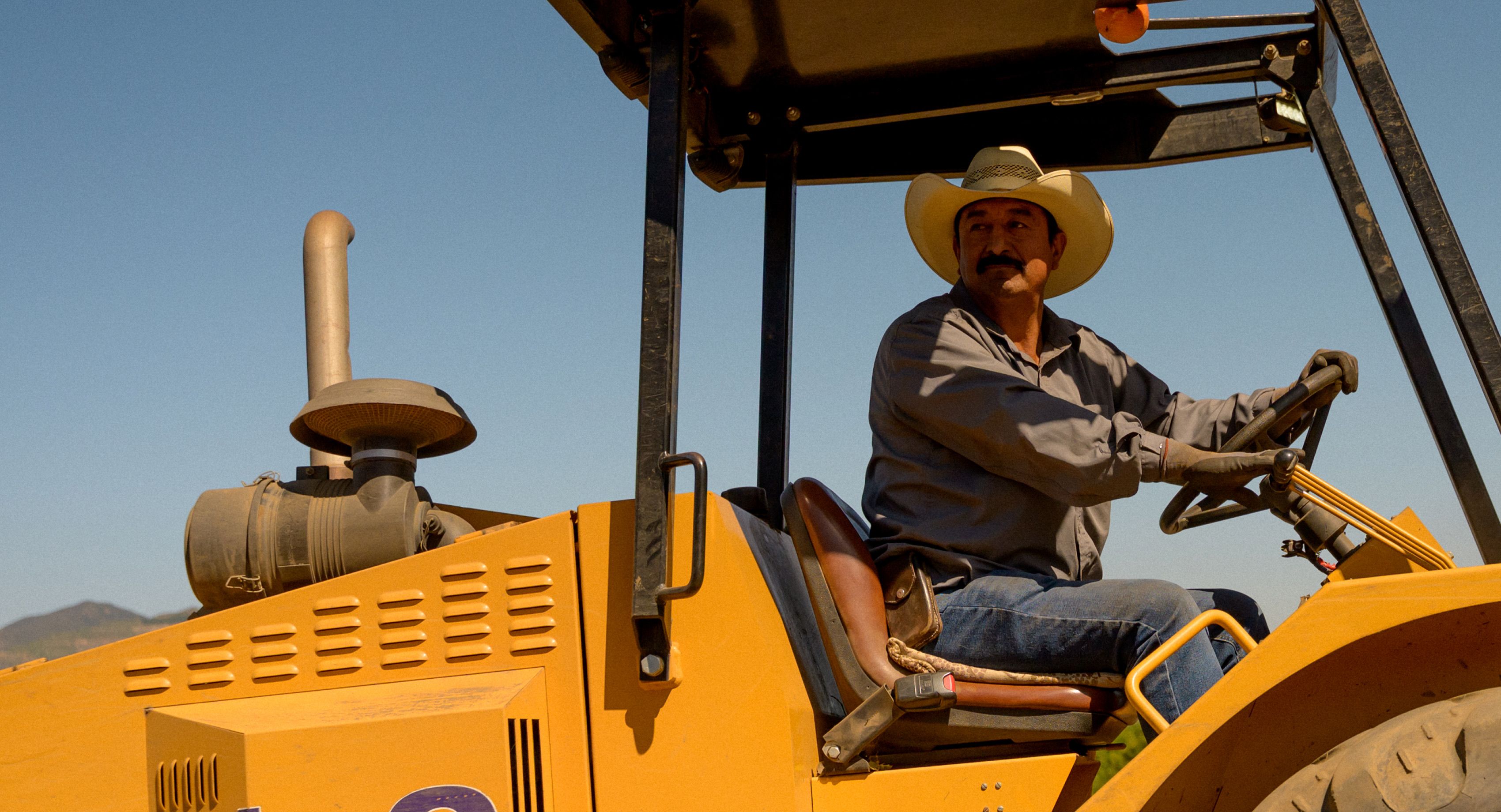 Farmer on yellow tractor