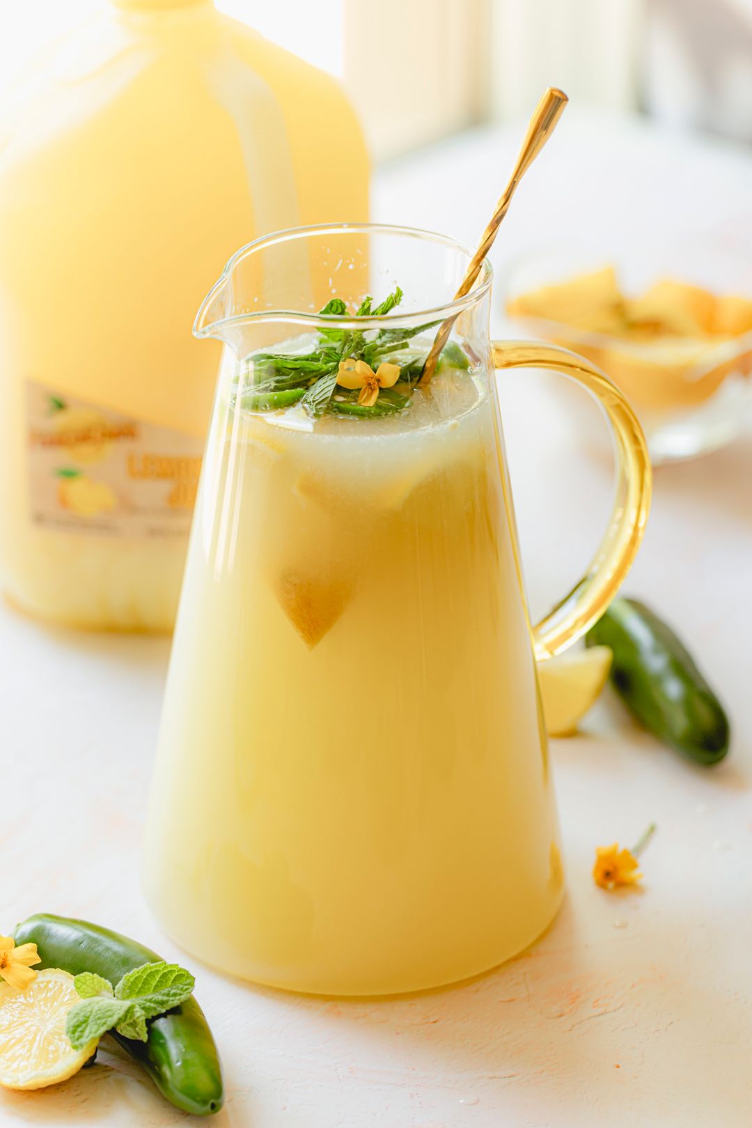 Pineapple Mojito Mocktail made with Perricone Farms Pineapple Juice, mint, and lime, served over ice with fresh pineapple and club soda in a short glass