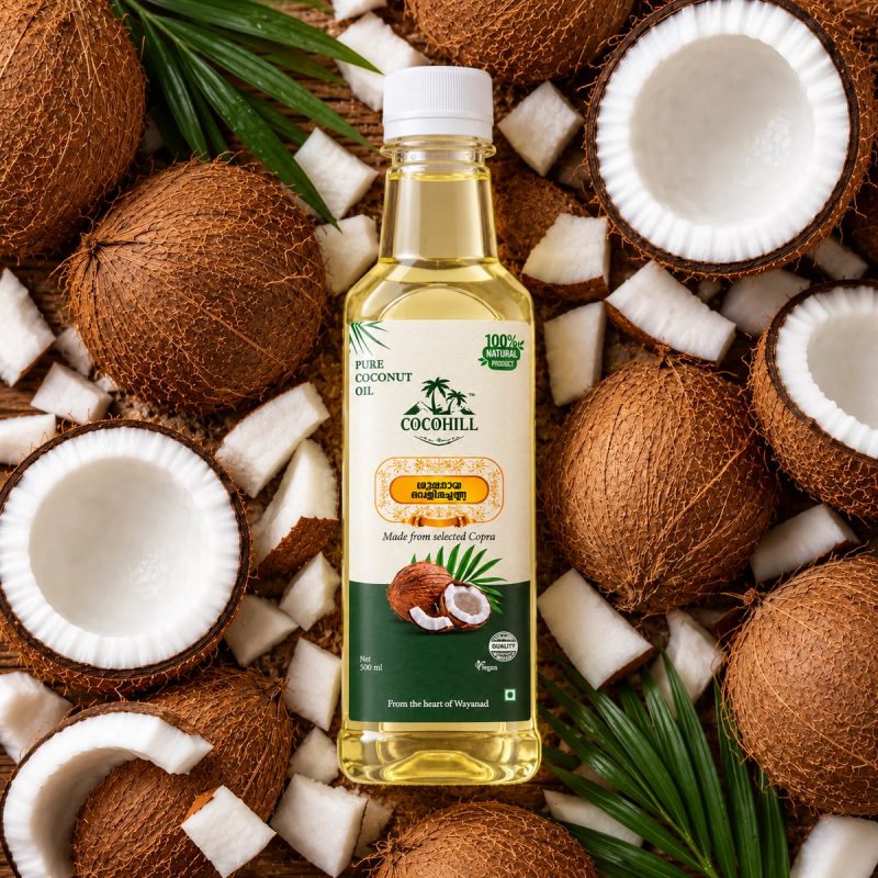 Cocohill coconut oil bottle nestled among fresh coconut halves, whole coconuts and green palm leaves