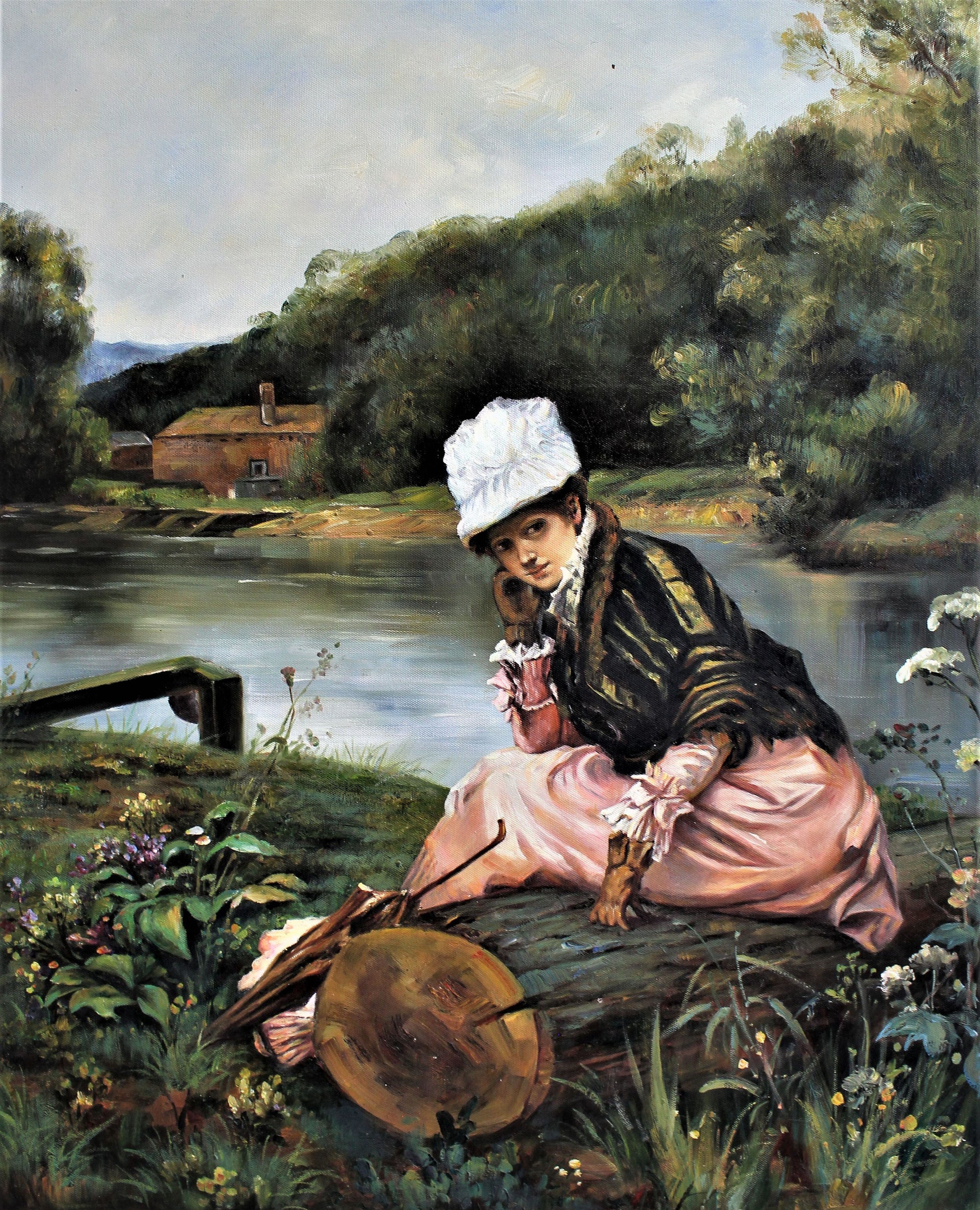 Femme assise au bord de la rivière