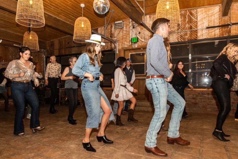 A full line of dancers stepping together across the Buckhorn's dance floor