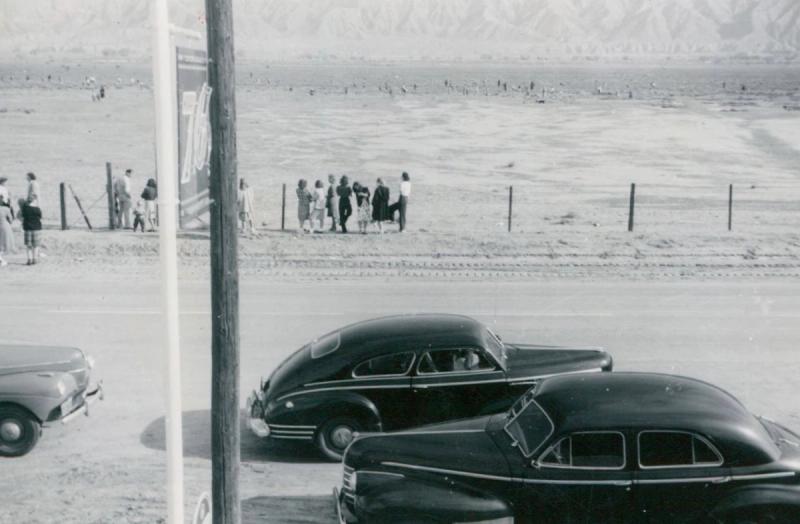 Vintage cars parked along a dusty road in the Cuyama Valley.
