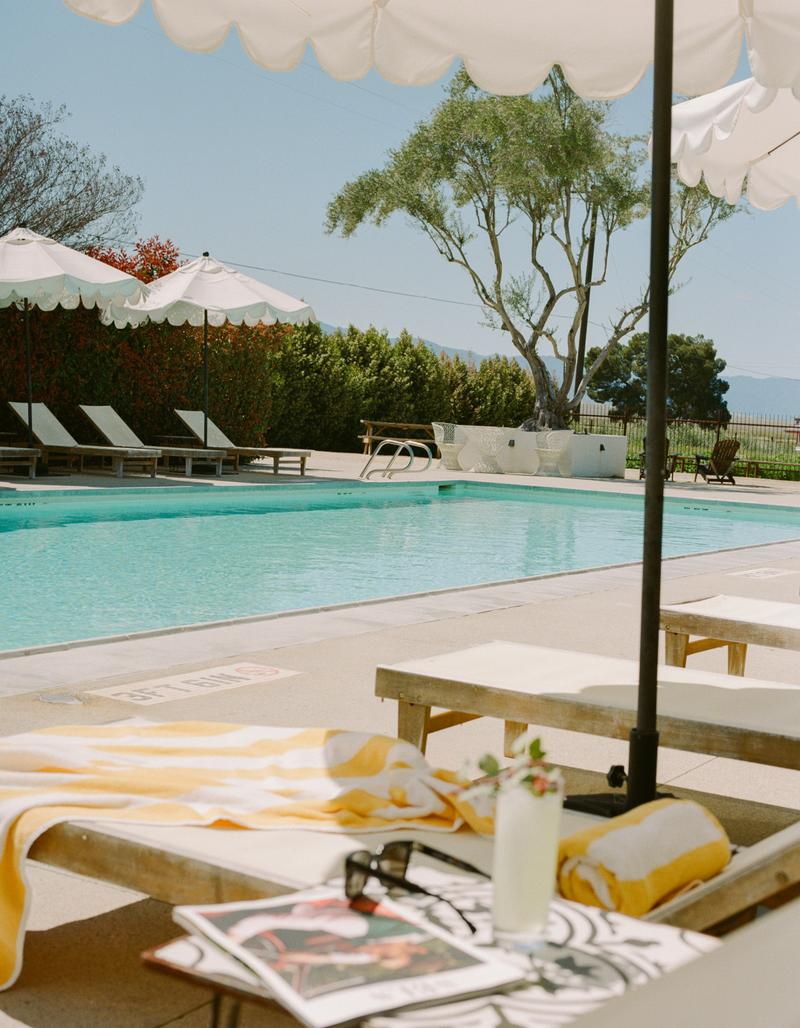 A poolside drink served on a tiled side table