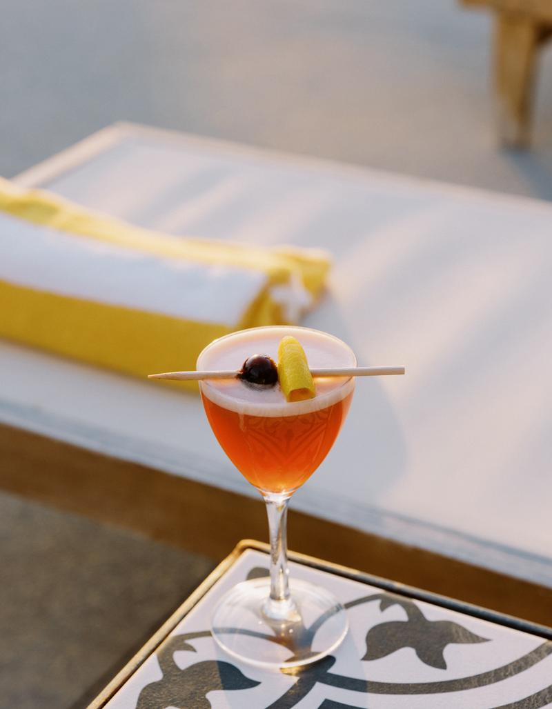 A poolside drink served on a tiled side table