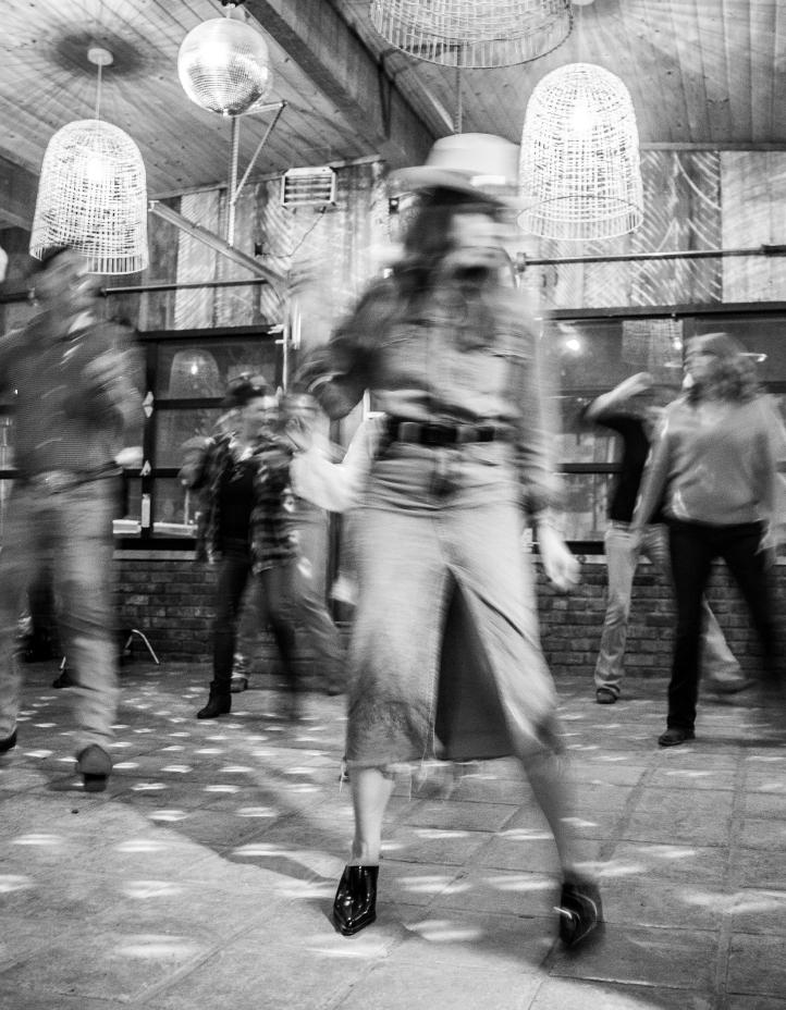 A dancer mid-spin on the floor, caught in motion blur