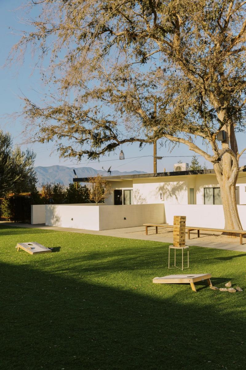 Cornhole boards and a ring toss game on the lawn with mountains beyond