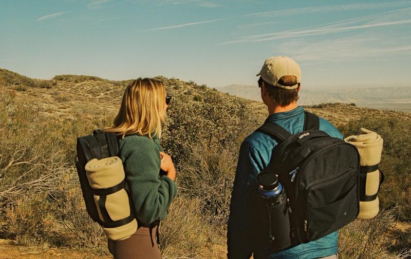 A couple hiking with their picnic backpacks