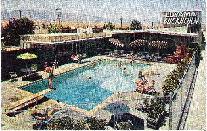 A vintage postcard of the Cuyama Buckhorn pool deck, guests sunbathing under striped umbrellas.