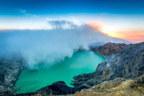 Sunrise over the turquoise acidic crater lake at Kawah Ijen, East Java