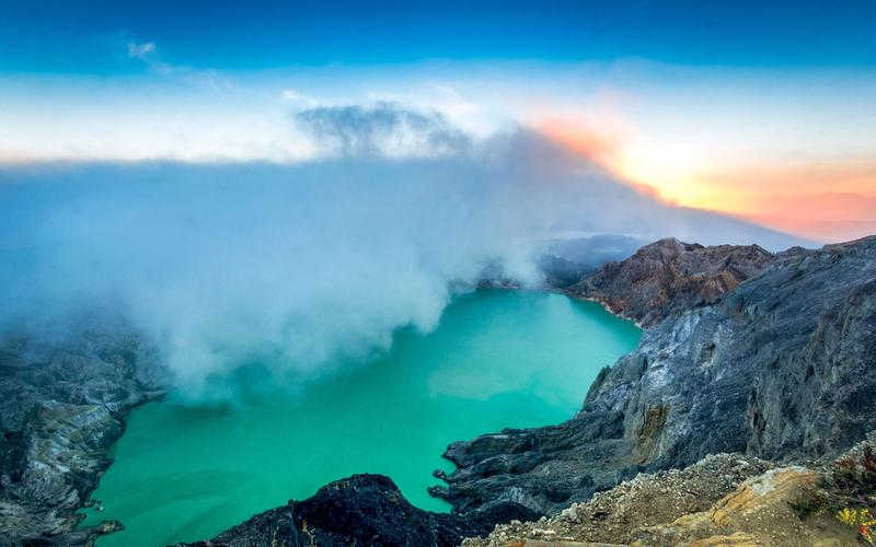 Sunrise over the turquoise acidic crater lake at Kawah Ijen, East Java
