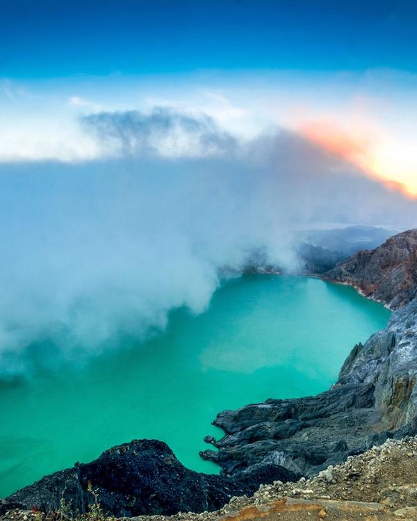 Sunrise over the turquoise acidic crater lake at Kawah Ijen, East Java