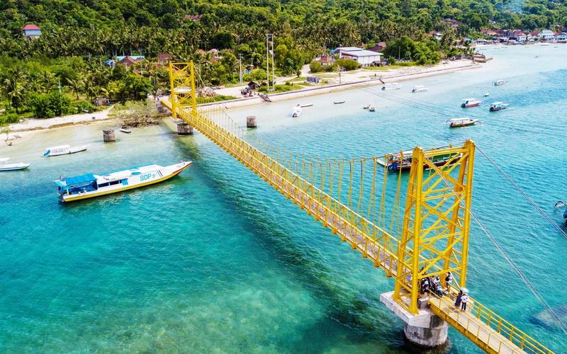 The yellow suspension bridge linking Nusa Lembongan and Nusa Ceningan over a turquoise channel