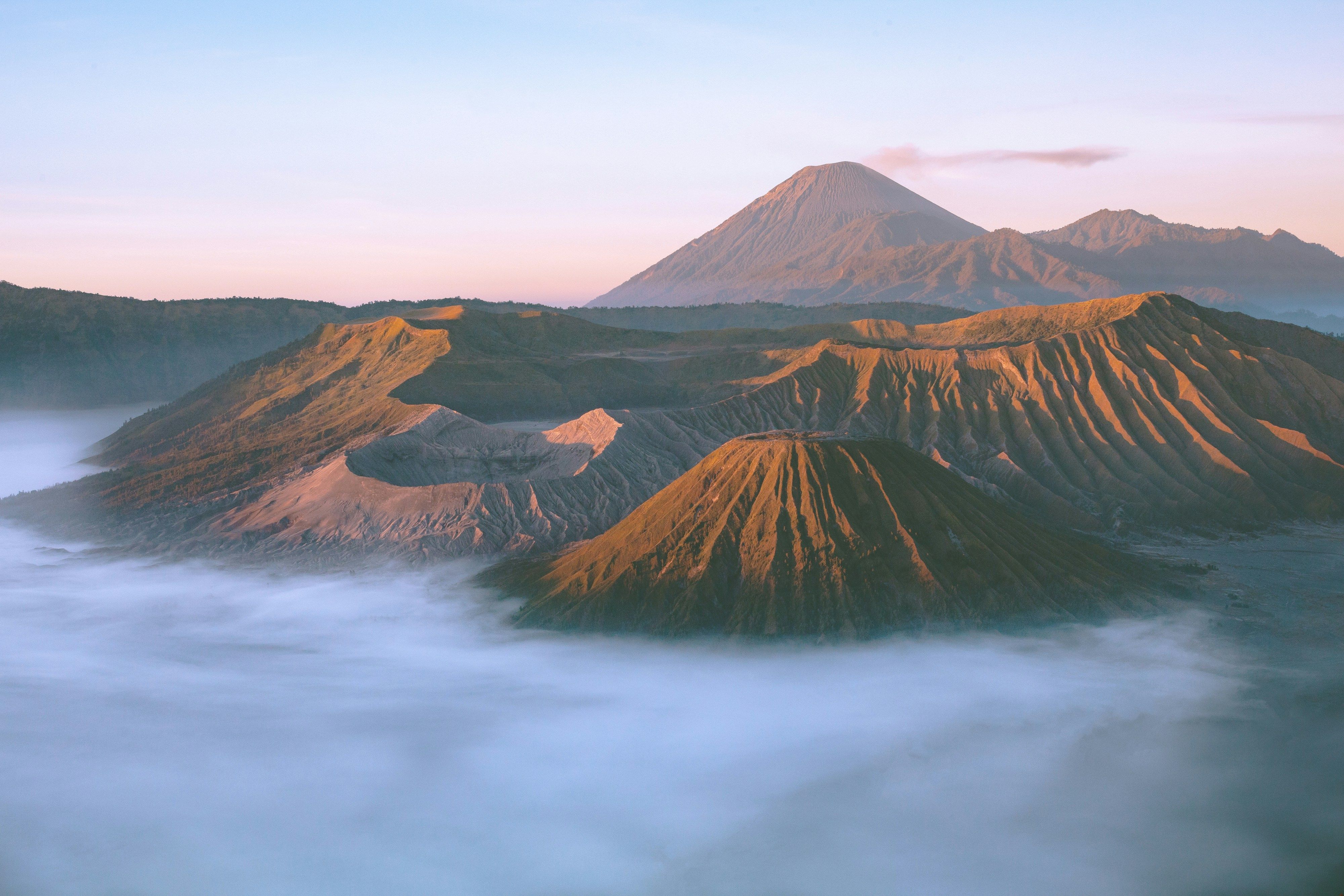 Java landscape with Borobudur temple sunrise and Mount Bromo volcano steam