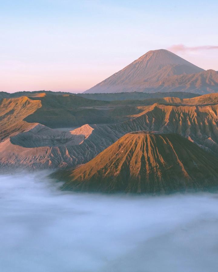 Java landscape with Borobudur temple sunrise and Mount Bromo volcano steam