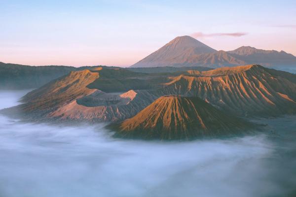Java landscape with Borobudur temple sunrise and Mount Bromo volcano steam