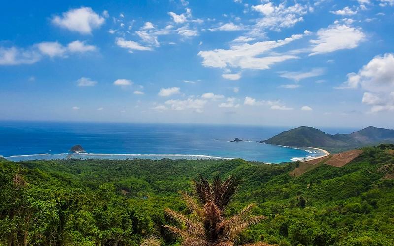 Mekaki Bay seen from the hills above Sekotong, southwest Lombok, with an empty beach and green headlands