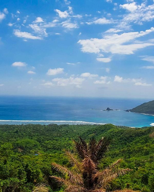 Mekaki Bay seen from the hills above Sekotong, southwest Lombok, with an empty beach and green headlands