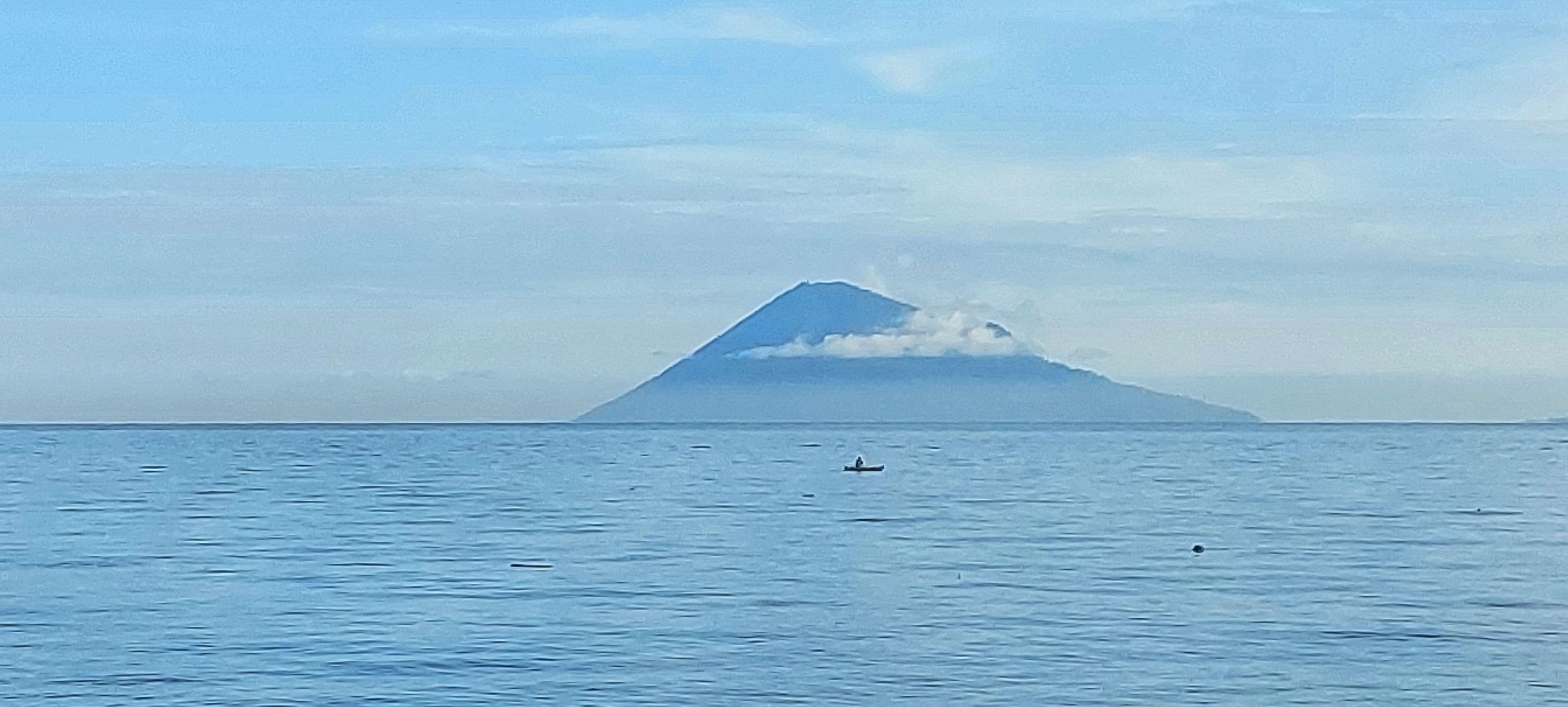 Manado Tua volcano rising from the sea off North Sulawesi, seen from the Bunaken marine park