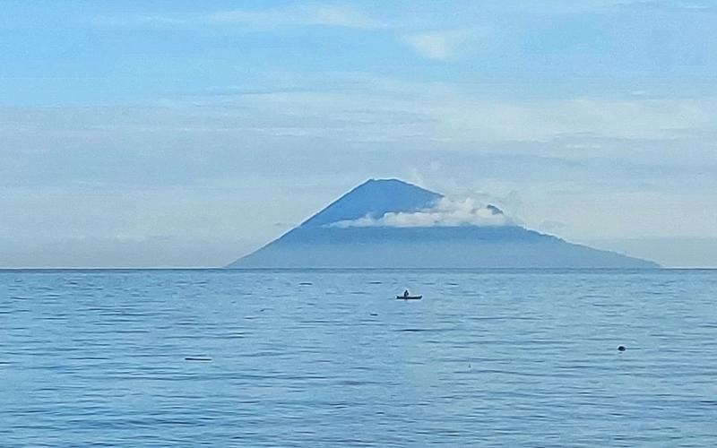 Manado Tua volcano rising from the sea off North Sulawesi, seen from the Bunaken marine park