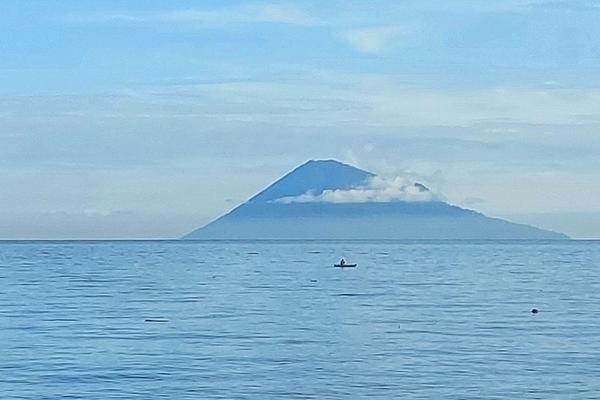 Manado Tua volcano rising from the sea off North Sulawesi, seen from the Bunaken marine park