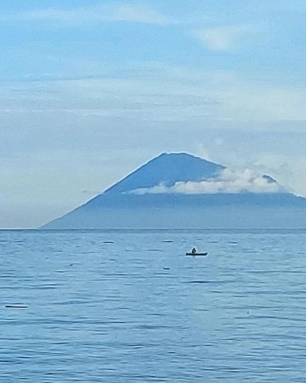 Manado Tua volcano rising from the sea off North Sulawesi, seen from the Bunaken marine park