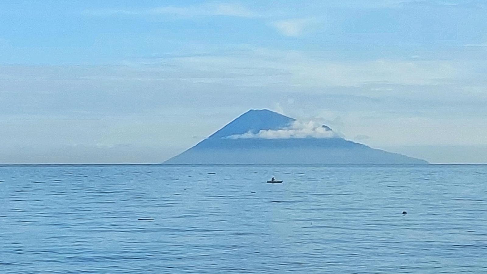 Manado Tua volcano rising from the sea off North Sulawesi, seen from the Bunaken marine park