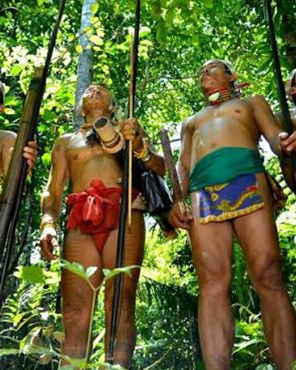 Mentawai men in traditional dress holding hunting bows in the Siberut rainforest