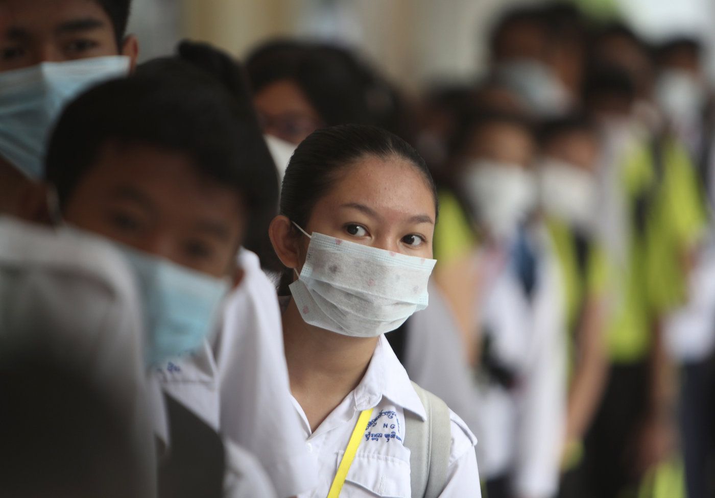 Students line up to sanitize their hands to avoid the contact of coronavirus before their morning class at a hight school in Phnom Penh, Cambodia, Tuesday, Jan. 28, 2020. China on Tuesday reported 25 more deaths from a new viral disease, as the U.S. government prepared to fly Americans out of the city at the center of the outbreak. (AP Photo/Heng Sinith)