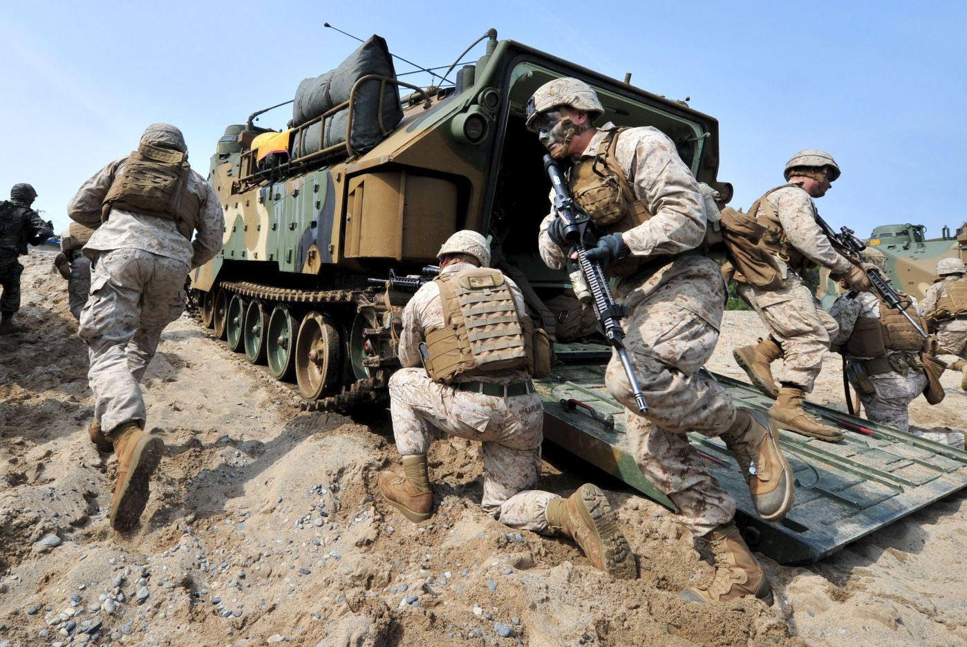TOPSHOTS 
 US Marines get out from an amphibious assault vehicle during a joint landing operation by US and South Korean Marines in Pohang, 270 kms southeast of Seoul, on March 31, 2014. North Korea announced a live-fire drill on March 31 near its disputed maritime border with South Korea, further ratcheting up tensions a day after threatening a "new form" of nuclear test.  AFP PHOTO / JUNG YEON-JE
