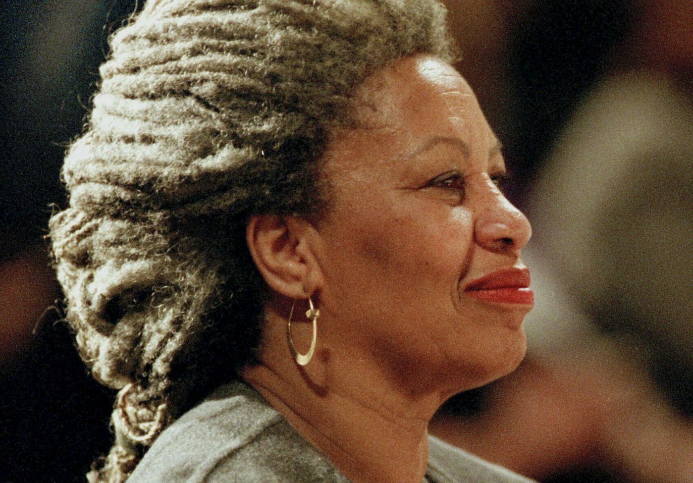 FILE - In this April 5, 1994 file photo, Toni Morrison as she holds an orchid at the Cathedral of St. John the Divine in New York.   The Nobel Prize-winning author has died. Publisher Alfred A. Knopf says Morrison died Monday, Aug. 5, 2019 at Montefiore Medical Center in New York. She was 88. (AP Photo/Kathy Willens, File)