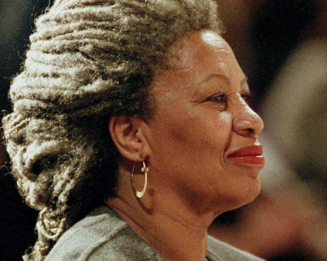 FILE - In this April 5, 1994 file photo, Toni Morrison as she holds an orchid at the Cathedral of St. John the Divine in New York.   The Nobel Prize-winning author has died. Publisher Alfred A. Knopf says Morrison died Monday, Aug. 5, 2019 at Montefiore Medical Center in New York. She was 88. (AP Photo/Kathy Willens, File)