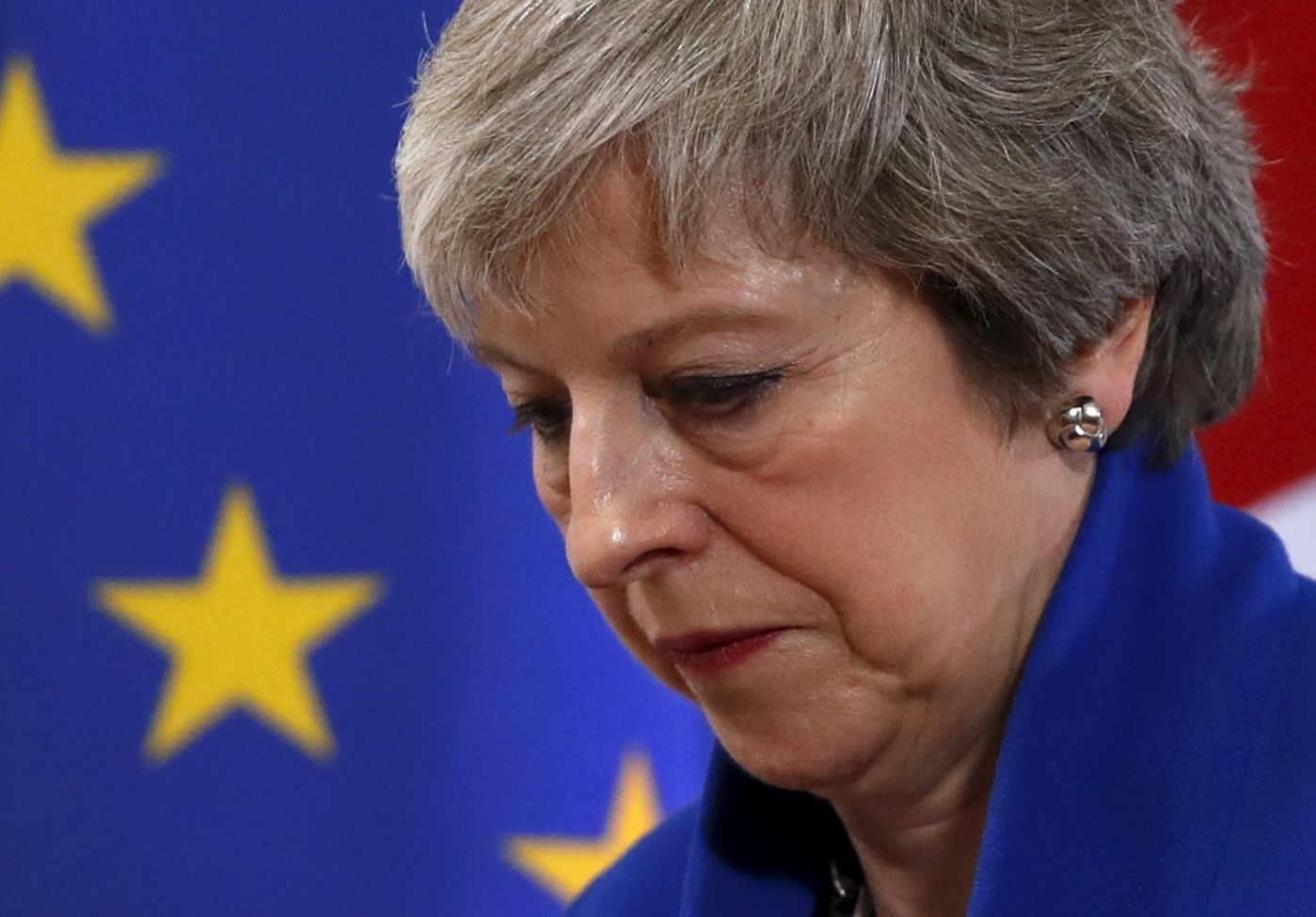 British Prime Minister Theresa May leaves the stand after a media conference in Brussels, Sunday, Nov. 25, 2018. European Union gathered on Sunday to seal an agreement on Britain's departure from the bloc next year, the first time a member country will have left the 28-nation bloc. (AP Photo/Alastair Grant)