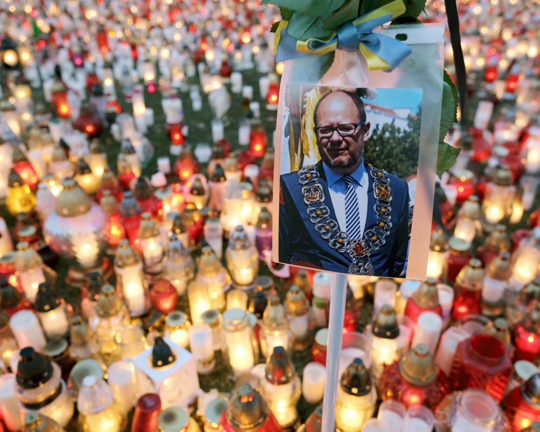 GDANSK, POLAND - JANUARY 17: A photograph of murdered Gdansk mayor Pawel Adamowicz hangs over a sea of candles left by mourners on January 17, 2019 in Gdansk, Poland. Adamowicz was stabbed on stage while attending a charity event in Gdansk last Sunday and died a day later of his injuries. The suspect is a 27-year-old man with a criminal record who was taken into custody. The coffin carrying Adamowicz's body is to be displayed in the European Solidarity Centre later today, where the public may come to pay last respects. Adamowicz's funeral is scheduled for Saturday.  (Photo by Sean Gallup/Getty Images)