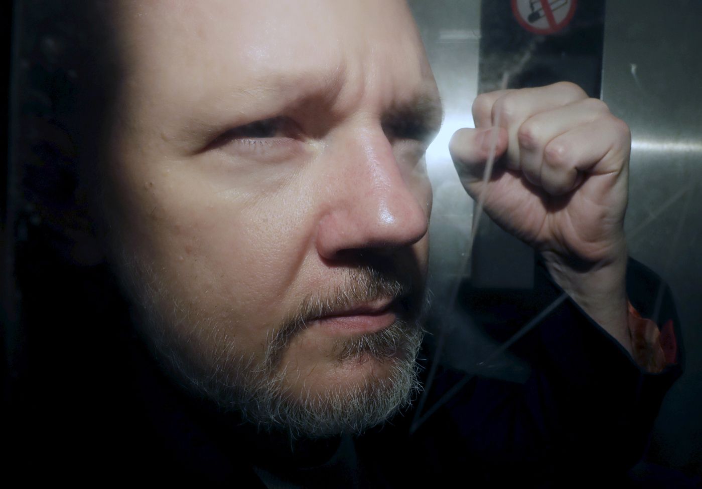 WikiLeaks founder Julian Assange being taken from court, where he appeared on charges of jumping British bail seven years ago, in London, Wednesday May 1, 2019. Assange has been jailed for 50 weeks for breaching his bail after going into hiding in the Ecuadorian embassy in London.(AP Photo/Matt Dunham)