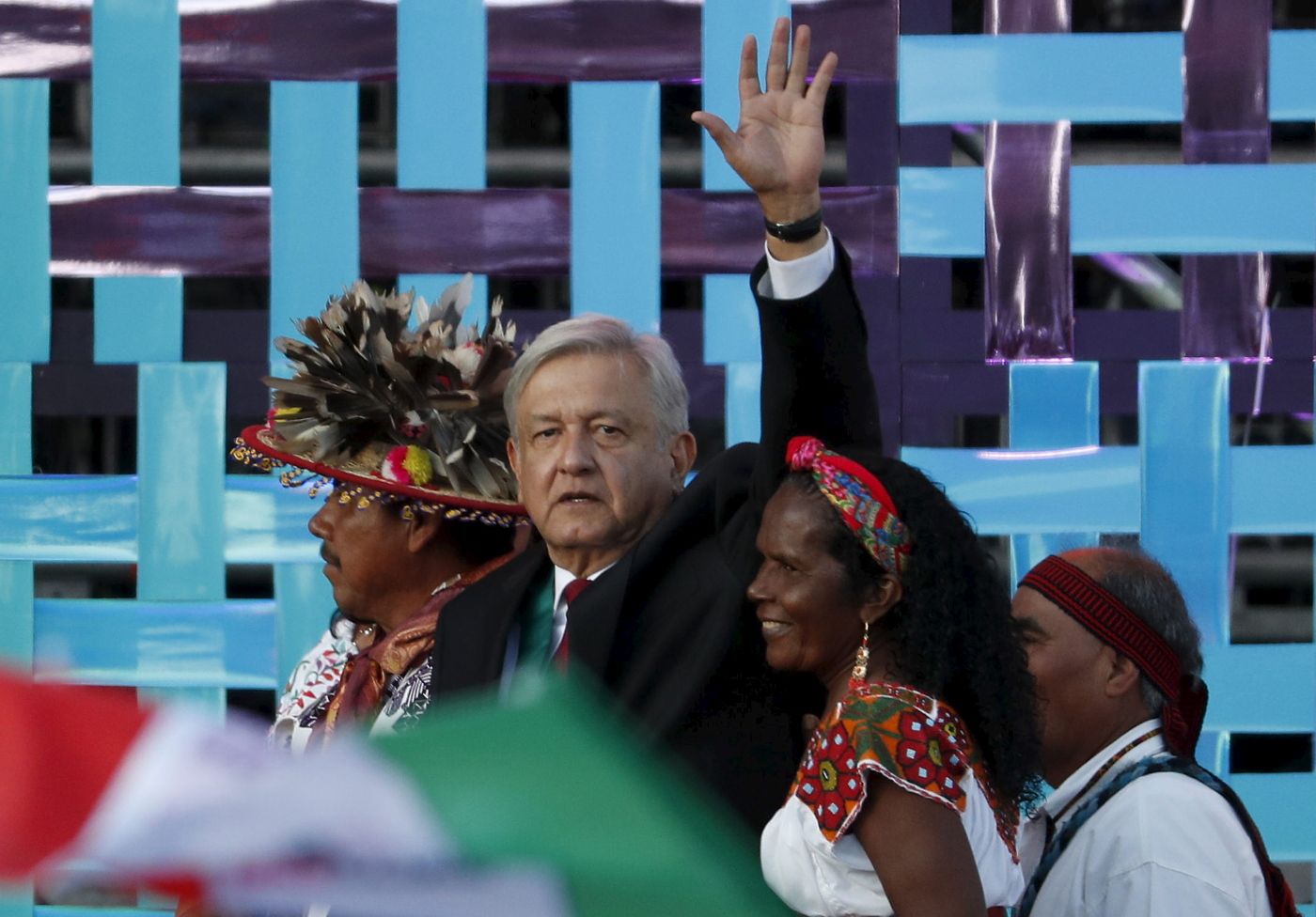 CORRECTS BYLINE - Mexico's new President Andres Manuel Lopez Obrador walks with indigenous religious leaders for a traditional indigenous ceremony at the Zocalo, in Mexico City, Saturday, Dec. 1, 2018. Mexicans are getting more than just a new president Saturday. The inauguration of Lopez Obrador will mark a turning point in one of the world's most radical experiments in opening markets and privatization. (AP Photo/Moises Castillo)