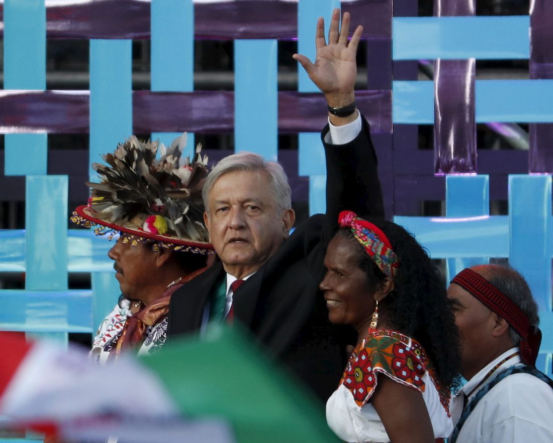 CORRECTS BYLINE - Mexico's new President Andres Manuel Lopez Obrador walks with indigenous religious leaders for a traditional indigenous ceremony at the Zocalo, in Mexico City, Saturday, Dec. 1, 2018. Mexicans are getting more than just a new president Saturday. The inauguration of Lopez Obrador will mark a turning point in one of the world's most radical experiments in opening markets and privatization. (AP Photo/Moises Castillo)