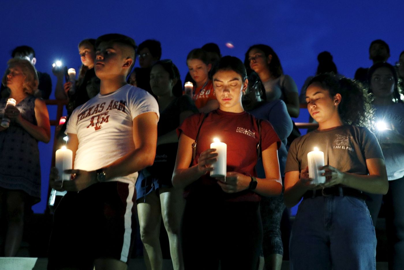 From left, Samuel Lerma, Arzetta Hodges and Desiree Quintanar attend a vigil for victims of the deadly shooting that occurred earlier in the day at a shopping center Saturday, Aug. 3, 2019, in El Paso, Texas. (AP Photo/John Locher)