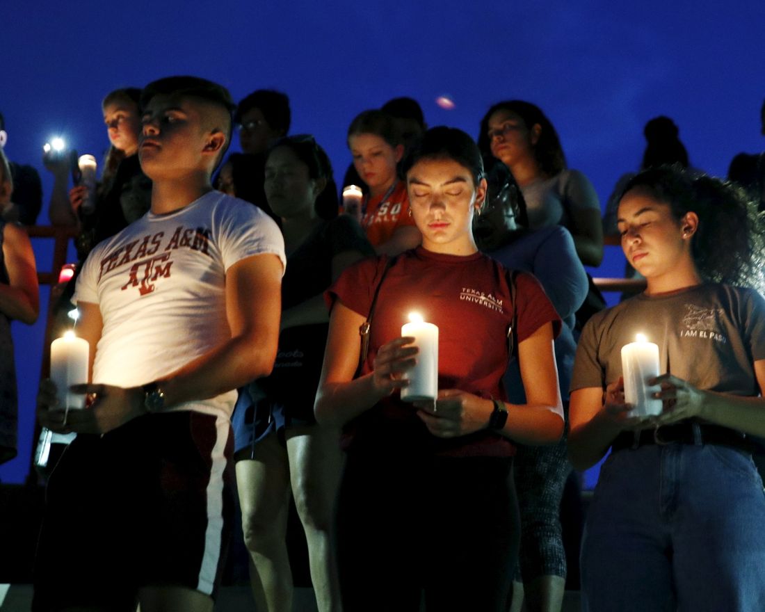 From left, Samuel Lerma, Arzetta Hodges and Desiree Quintanar attend a vigil for victims of the deadly shooting that occurred earlier in the day at a shopping center Saturday, Aug. 3, 2019, in El Paso, Texas. (AP Photo/John Locher)