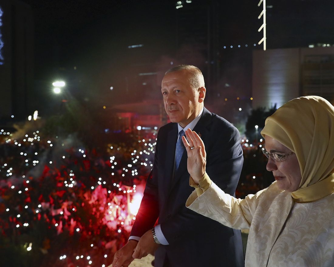 Turkey's President Recep Tayyip Erdogan, accompanied by his wife Emine waves to supporters of his ruling Justice and Development Party (AKP) in Ankara, Turkey, early Monday, June 25, 2018. Erdogan won Turkey's landmark election Sunday, the country's electoral commission said, ushering in a new system granting the president sweeping new powers which critics say will cement what they call a one-man rule (Presidency Press Service via AP, Pool)