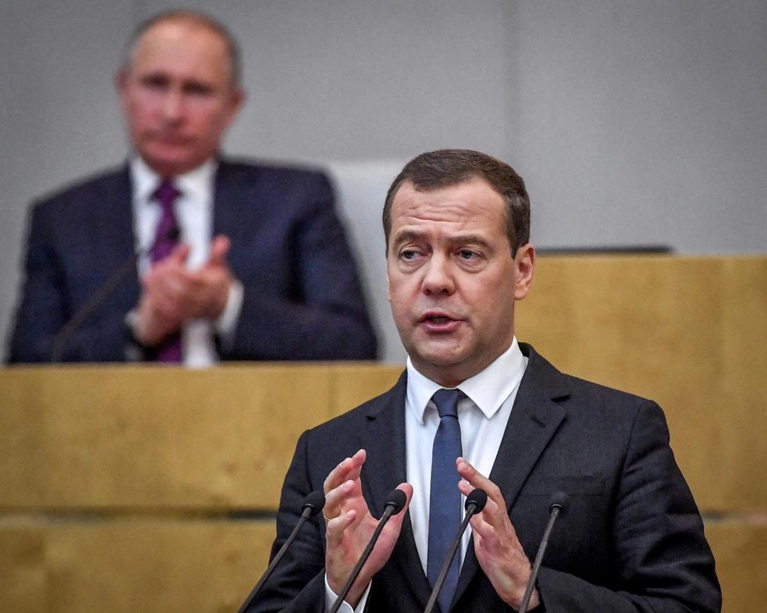 Russia's President Vladimir Putin and acting Prime Minister Dmitry Medvedev attend a session of the State Duma in Moscow on May 8, 2018. 
 The Russian parliament on May 8, 2018 voted to back a new mandate for prime minister Dmitry Medvedev, a longtime ally of President Vladimir Putin who also served a Kremlin term from 2008 to 2012. / AFP PHOTO / Yuri KADOBNOV