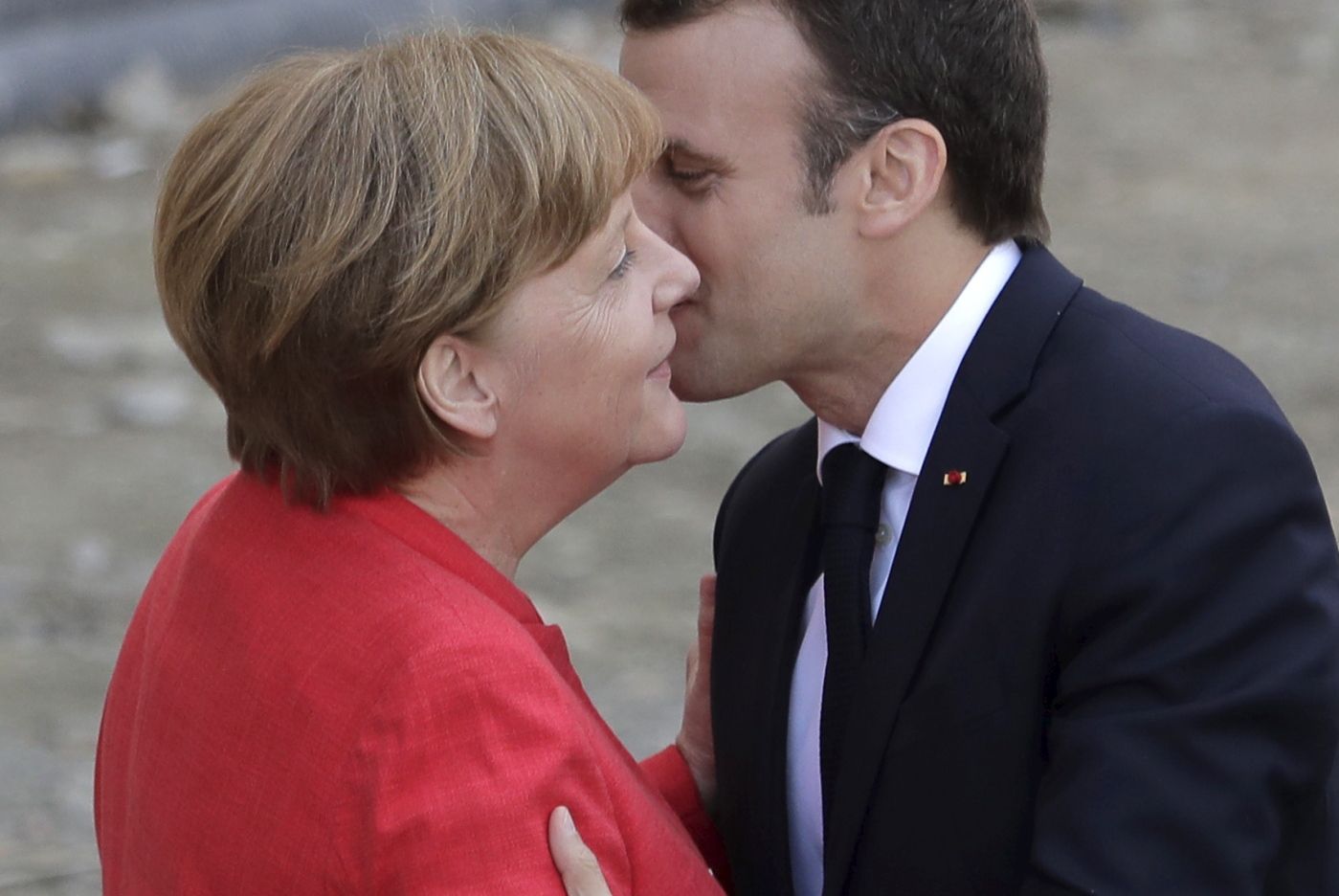 French President Emmanuel Macron, right, is welcomed by German Chancellor Angela Merkel before they visit the reconstruction site of the Berlin Palace in Berlin, Germany, Thursday, April 19, 2018. (AP Photo/Markus Schreiber)